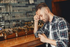 Attractive young man standing behind the bar.