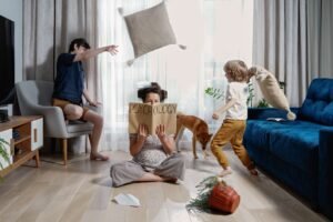 calm pregnant mother reading psychology magazine in middle of family chaos. Psychology. Family fun