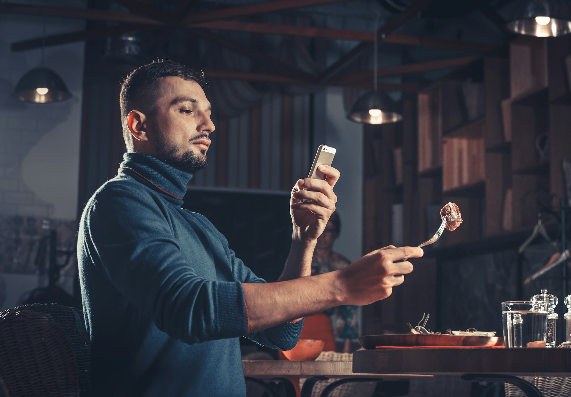 man photographing food